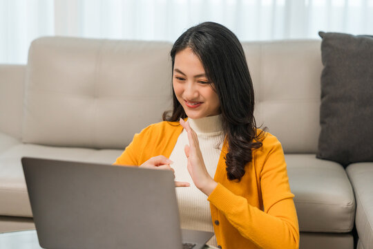 Young deaf asian woman showing sign language. a woman with hearing disability having communication with hands gestures Communicate online using sign language via a laptop.