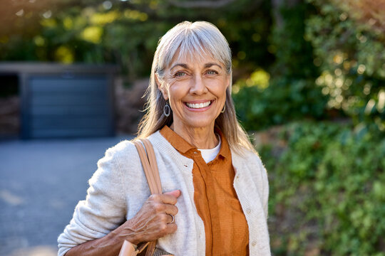 Smiling healthy mature woman looking at camera outdoor