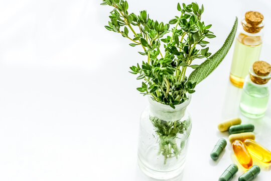 Herbal formulations for health care - herbs and drugs on white background copy space