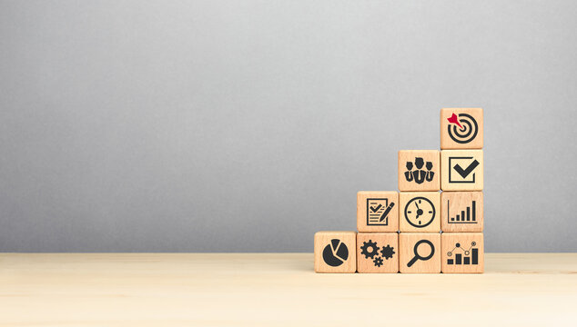 Wooden cubes stacking as step stair with business strategy icons. Ladder of success in business growth concept. copy space