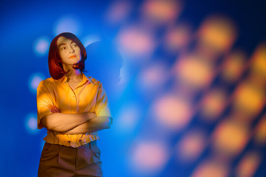Thoughtful woman experiences augmented reality in creative lighting