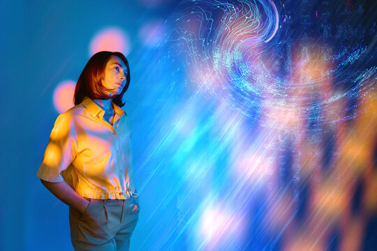 Mature woman looking at surreal digital light projection