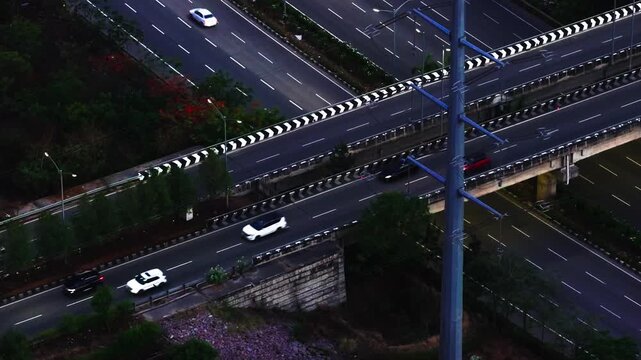 Multi-Lane Expressway Flyover with vehicles, Monopole Transmission Tower and twilight at Hyderabad, telangana, india. sun set time, blue hour, static shot, drone shot, 4k.