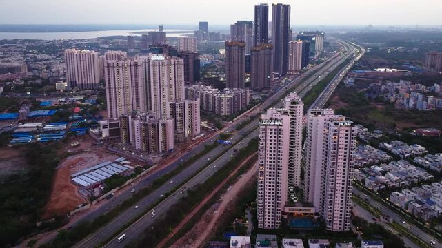 skyscraper with villas, outer ring road, haze and Kokapeta Lake at kokapet, financial district, nanakramguda, hyderabad, telangana, india. day time, trucking shot, drone shot, 4k.