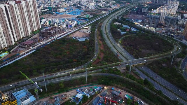 Modern Highway Interchange with Skyscrapers, and City Infrastructure at narsingi, kokapet, nanakramguda, Hyderabad, telangana, india. day time, top down shot, static shot, drone shot, 4k.