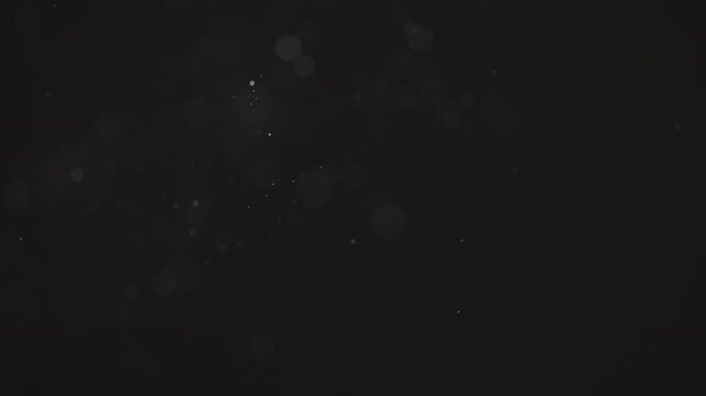 Floating dust particles over dark background with shallow focus