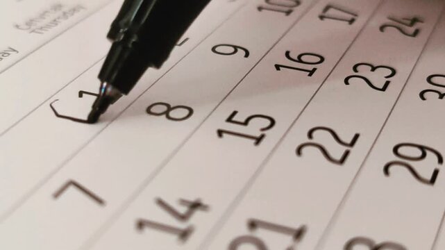 Man circling event date reminder on month calendar - First day in month calculator	