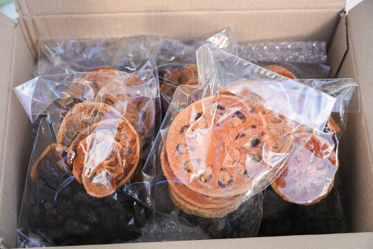 Assorted dehydrated fruit slices in sealed plastic bags inside cardboard box