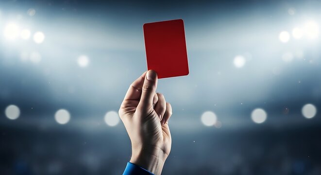 referee showing red card to player in stadium