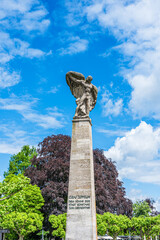 Count Zeppelin monument stands tall over Lake Constance in Konstanz, Germany, surrounded by greenery and blue skies on a bright day © Daniela Baumann