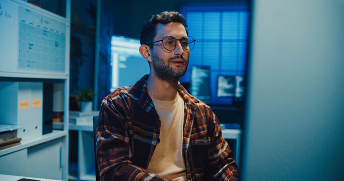 Young Caucasian male programmer write code on computer in home office at late night. AI technology, cybersecurity, software developer, freelance innovation, database system, digital network concept.