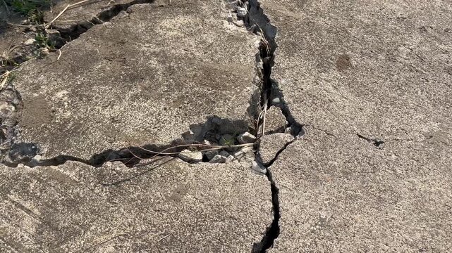 Severe structural crack on weathered concrete surface