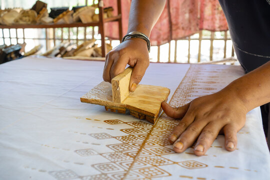 Traditional Batik Stamping Process on White Cloth in Indonesia
