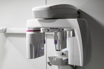 Modern dental panoramic X-ray unit in a clean clinical environment, featuring advanced digital imaging equipment for dental diagnostics © ugis