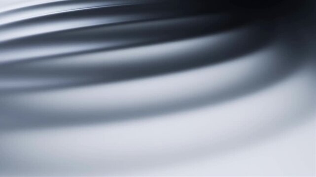 Blurred abstract lines create a futuristic metallic wave on a flat surface