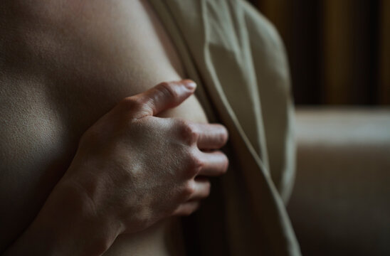 Close up of hand touching breast for health examination