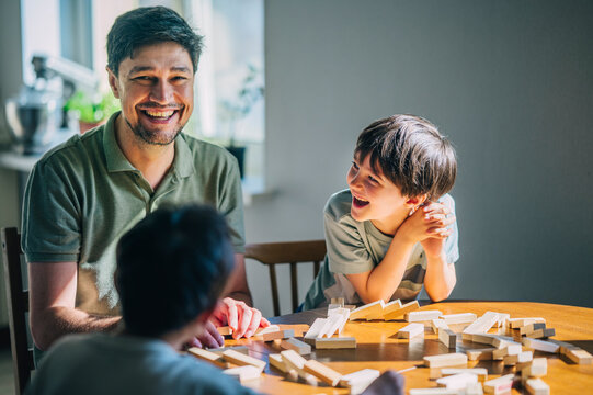 Father playing educational game with child indoors