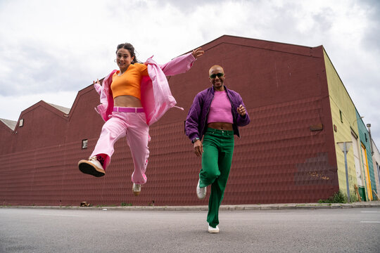 Happy couple having fun together in front of building