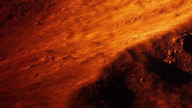 Surface of a planet displays orange and red hues with rocky textures under a bright light source. The scene represents an alien landscape that is barren and rugged.