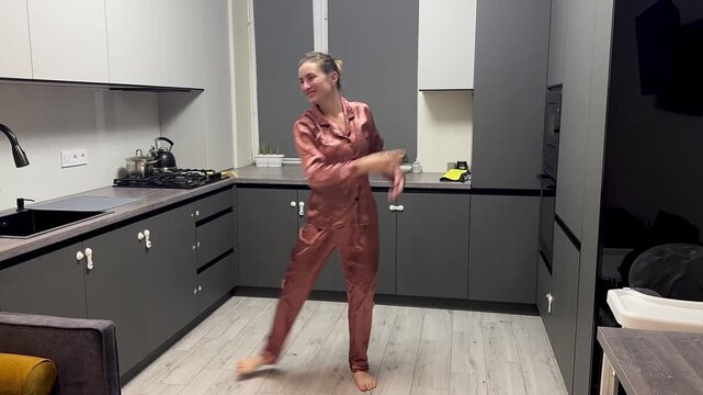 Happy woman dancing in pajamas at home, authentic smartphone video