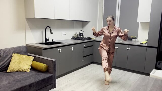 Happy woman dancing in pajamas at home, authentic smartphone video