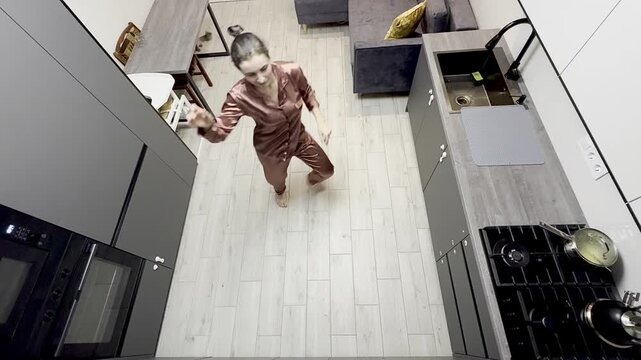 Happy woman dancing in pajamas at home, authentic smartphone video
