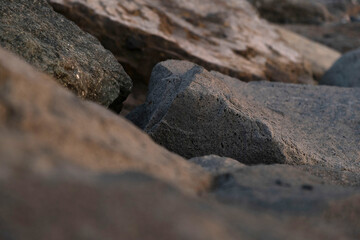 Close up abstract of large rough grey boulder structures © Maria