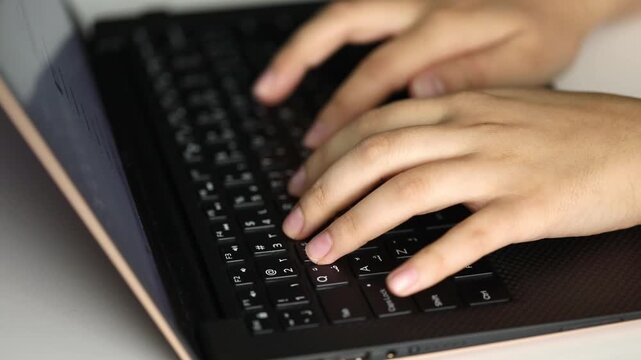 female hands typing on a laptop
