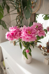 Fototapeta premium A bouquet of beautiful peonies in a home interior