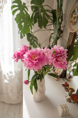 A bouquet of beautiful peonies in a home interior © Olga Tkacheva