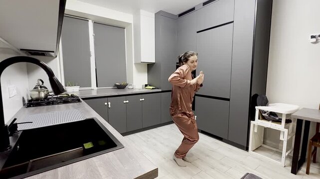 Happy woman dancing in pajamas at home, authentic smartphone video