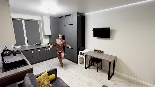 Happy woman dancing in pajamas at home, authentic smartphone video