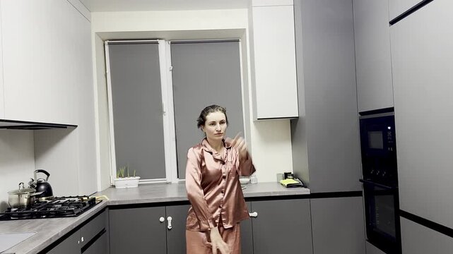 Happy woman dancing in pajamas at home, authentic smartphone video