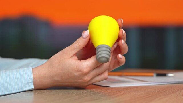 A girl twirling a lightbulb in her hand&mdash;an idea. Inspiration, wisdom, and a willingness to learn new things. Business and education.