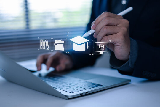 Close Up of Businessman Using Laptop and Tablet for choosing education icon at Modern Office Desk with Digital Finance and Communication Technology