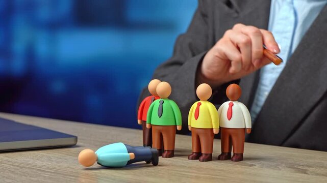 A businesswoman dismisses an employee from her team. Dismissing the team leader risks disruption. A rash move in business management.