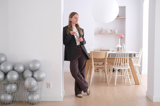 Femal entrepreneur standing in modern home office workspace