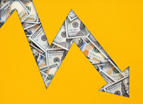 US dollar bills creating a downward economic arrow