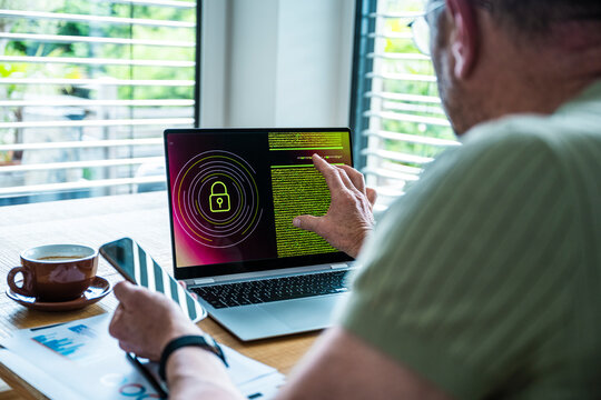 Man analyzes cyber security code on a laptop in the office