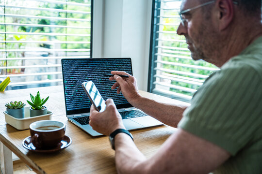 A man analyzes data on a notebook screen in the office