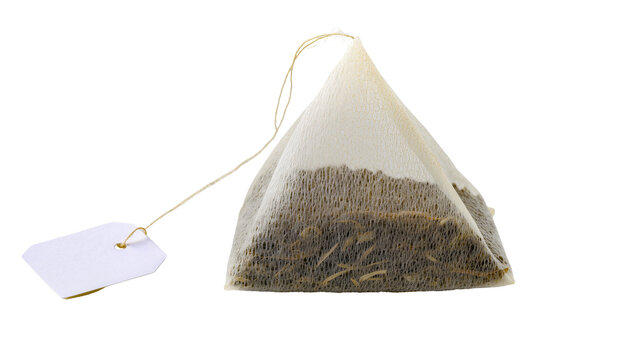 Pyramid tea bag with dry tea leaves and white tag
