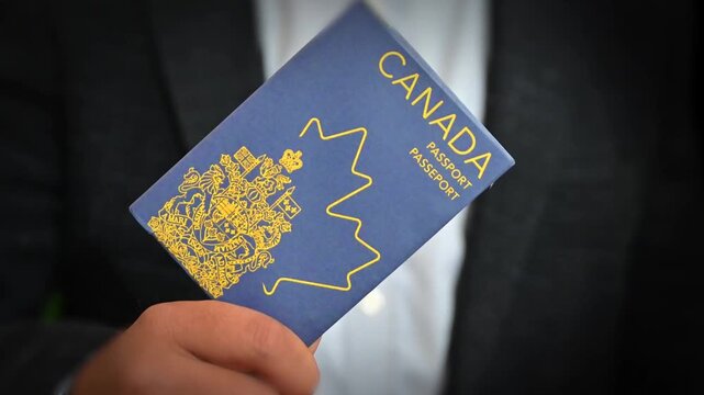 Close-up of Canadian passport held in hand highlighting cover design and text travel document concept 4k footage