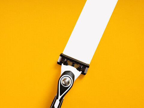 Manual razor shaving strip on yellow background
