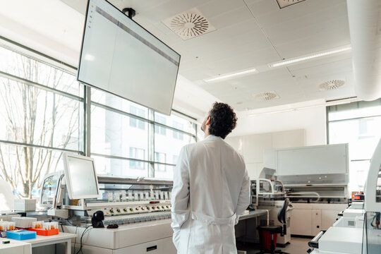 Scientist analyzing data on monitor in modern laboratory