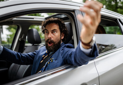 Frustrated man in car stuck in traffic