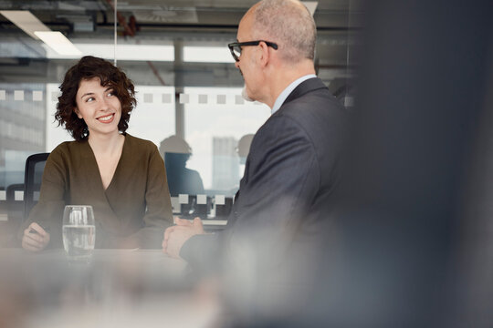 A woman and man are having a business meeting in a London office