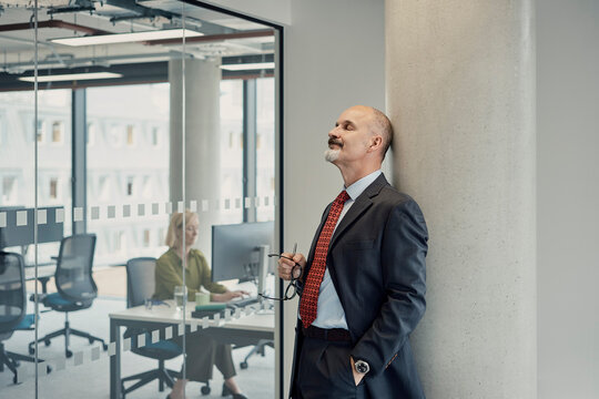 Businessman takes a break in modern office near female colleague