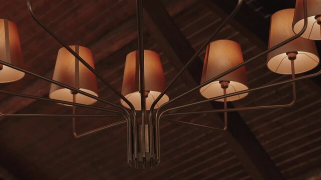 Multi arm metal chandelier with warm fabric shades glowing beneath a dark wooden beam ceiling