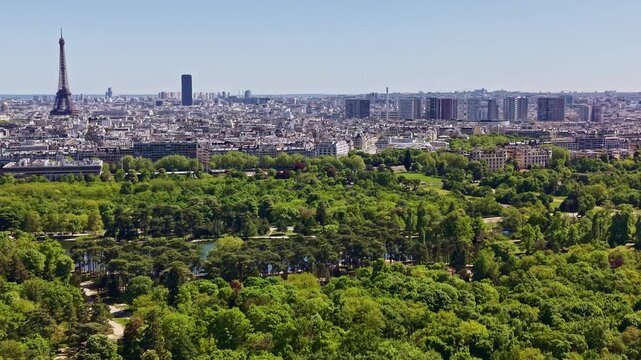 Bois de Boulogne with the Eiffel Tower, Tour Montparnasse and La D&eacute;fense skyline, Paris, &Icirc;le-de-France, France, revealing Europe's largest urban woodland, drone pullback