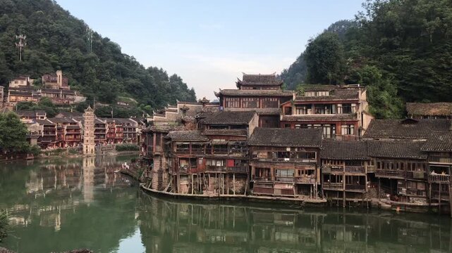 Fenghuang Ancient Town in Hunan, China, featuring traditional Chinese architecture, riverside stilt houses, cobblestone streets, and a well-preserved historic setting.